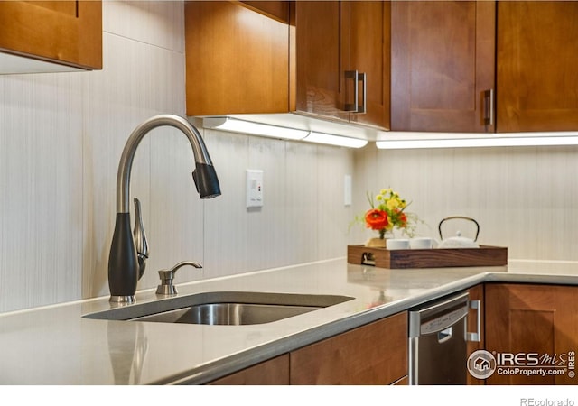 4795 Tantra Dr, Boulder, CO 80305 - kitchen featuring a sink, stainless steel dishwasher, brown cabinets, and light countertops