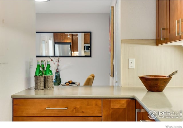 4795 Tantra Dr, Boulder, CO 80305 - kitchen with stainless steel appliances, brown cabinetry, and light countertops