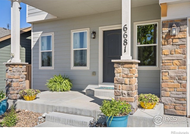 6681 6th St, Frederick, CO 80530 - view of exterior entry with covered porch and stone siding