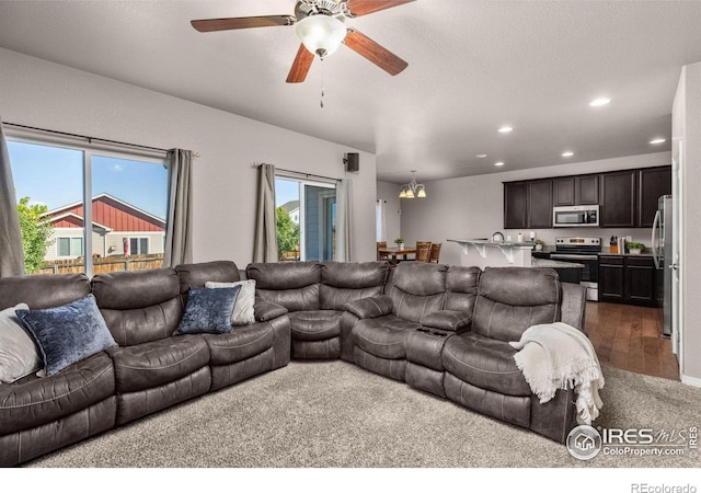 6681 6th St, Frederick, CO 80530 - living room with recessed lighting, a ceiling fan, and dark colored carpet