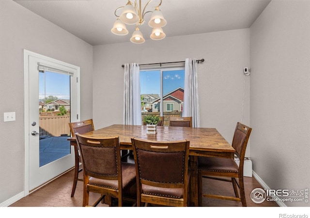 6681 6th St, Frederick, CO 80530 - dining space with a chandelier, healthy amount of natural light, baseboards, and wood finished floors