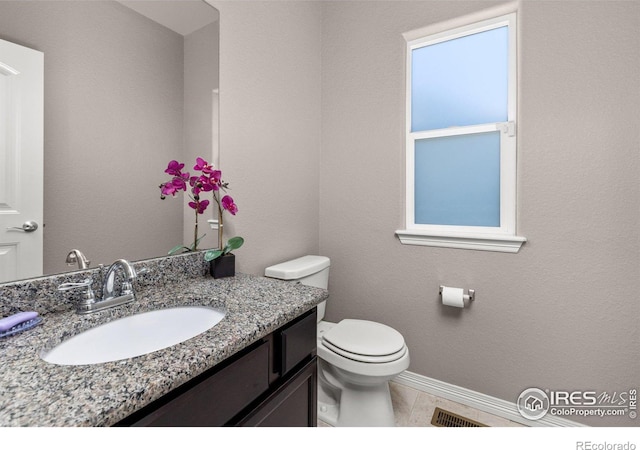 6681 6th St, Frederick, CO 80530 - bathroom with vanity, toilet, baseboards, and tile patterned flooring