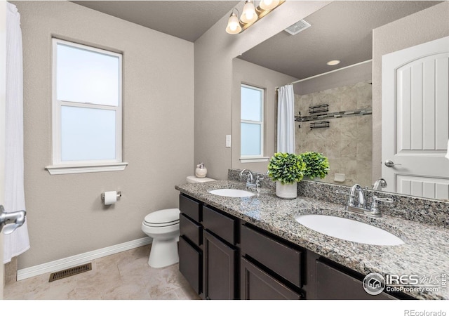 6681 6th St, Frederick, CO 80530 - full bath featuring baseboards, double vanity, toilet, a shower with curtain, and tile patterned flooring