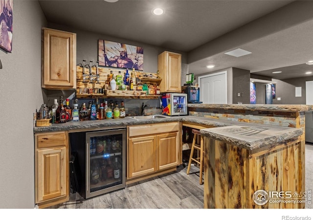 6681 6th St, Frederick, CO 80530 - indoor wet bar with beverage cooler, light wood-style flooring, and recessed lighting