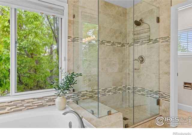 5348 Wild Dunes Ct, Boulder, CO 80301 - full bathroom featuring a shower stall and a bath