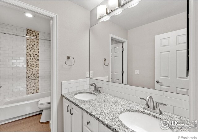5348 Wild Dunes Ct, Boulder, CO 80301 - full bath with toilet, bathtub / shower combination, double vanity, and decorative backsplash