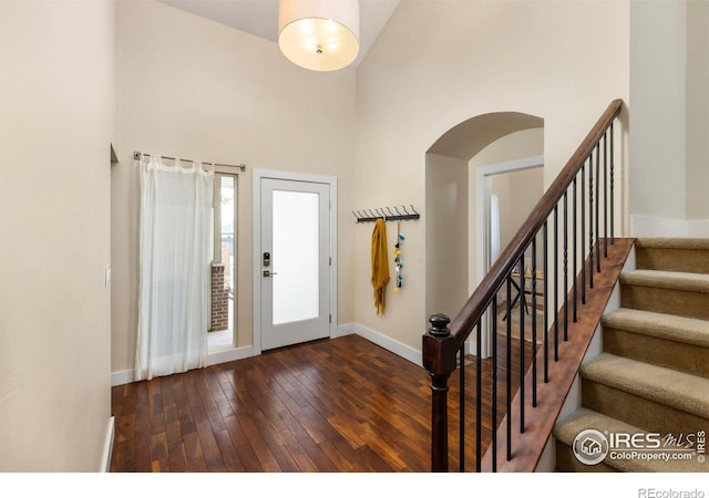 4924 Clubhouse Ct, Boulder, CO 80301 - entrance foyer with a towering ceiling, baseboards, hardwood / wood-style flooring, stairs, and arched walkways