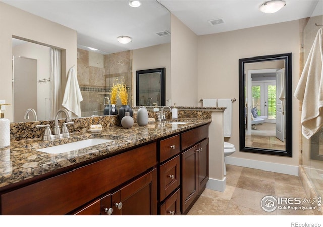 4924 Clubhouse Ct, Boulder, CO 80301 - full bathroom with double vanity, toilet, baseboards, tiled shower, and french doors