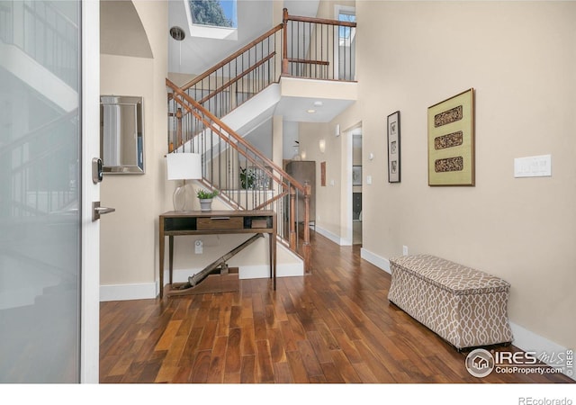 4924 Clubhouse Ct, Boulder, CO 80301 - foyer entrance featuring wood finished floors, stairway, a skylight, and a towering ceiling