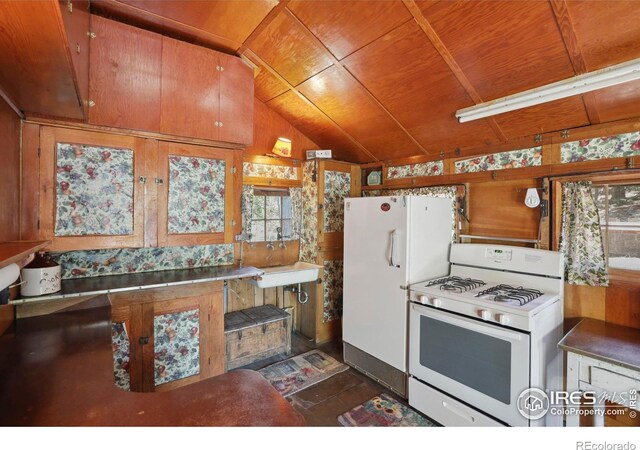 12991 Peak To Peak Hwy, Allenspark, CO 80510 - kitchen with white appliances, lofted ceiling, wooden ceiling, wood walls, and a sink