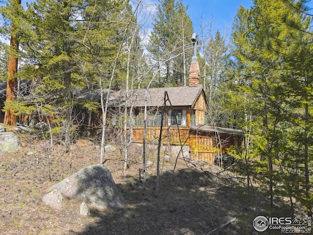 12991 Peak To Peak Hwy, Allenspark, CO 80510 - rear view of property with a chimney