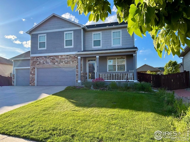 6722 Grainery Rd, Timnath, CO 80547 - view of front of house with covered porch, stone siding, concrete driveway, and an attached garage
