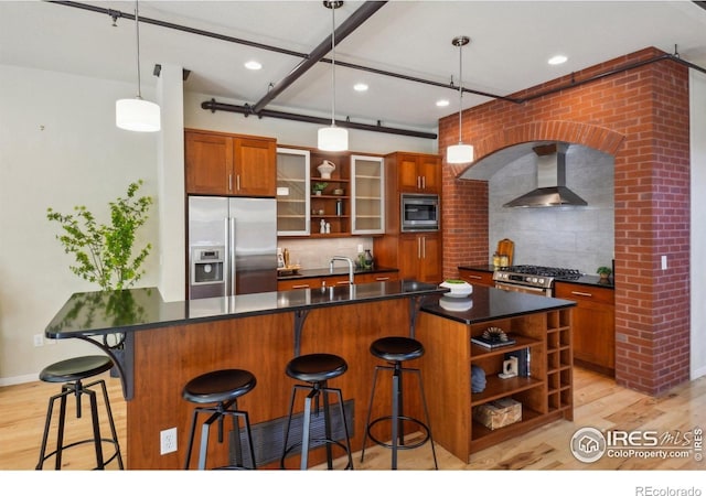 1203 High St, Boulder, CO 80304 - kitchen with appliances with stainless steel finishes, open shelves, wall chimney exhaust hood, dark countertops, and light wood finished floors