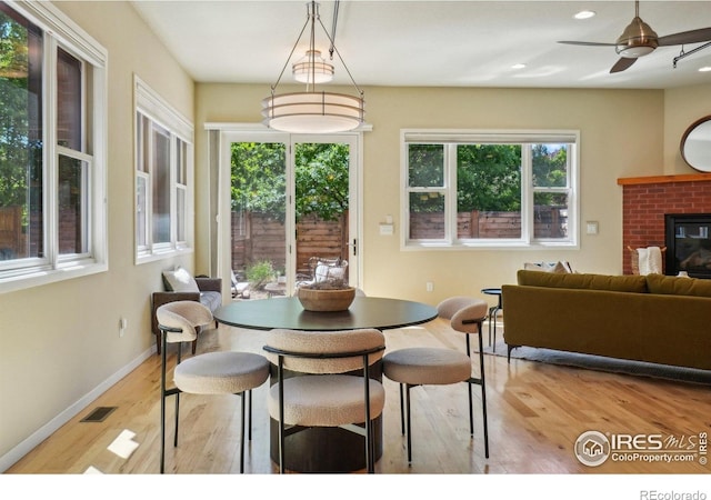 1203 High St, Boulder, CO 80304 - dining area featuring wood finished floors, plenty of natural light, a fireplace, a ceiling fan, and recessed lighting
