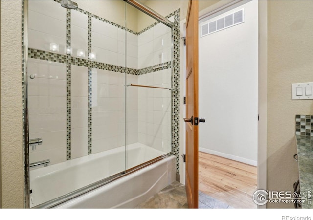 1203 High St, Boulder, CO 80304 - bathroom featuring combined bath / shower with glass door, wood finished floors, and baseboards