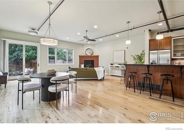 1203 High St, Boulder, CO 80304 - dining room with light wood-type flooring, recessed lighting, ceiling fan, and a fireplace