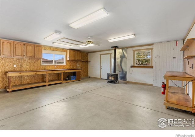 531 S 9th St, Berthoud, CO 80513 - garage with a wood stove and a workshop area