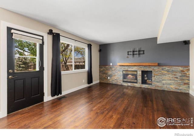 531 S 9th St, Berthoud, CO 80513 - unfurnished living room featuring a fireplace, wood finished floors, and baseboards