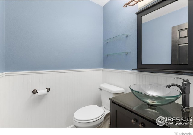 531 S 9th St, Berthoud, CO 80513 - bathroom with wainscoting, toilet, and vanity