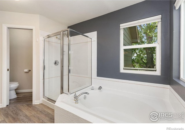 531 S 9th St, Berthoud, CO 80513 - full bath with a shower stall, toilet, a garden tub, and wood finished floors