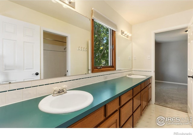 531 S 9th St, Berthoud, CO 80513 - bathroom featuring double vanity and baseboards