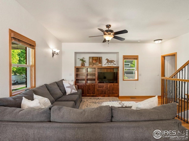 101 SE 2nd St, Berthoud, CO 80513 - living room featuring stairs, a ceiling fan, and wood finished floors