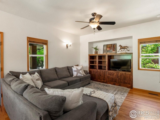 101 SE 2nd St, Berthoud, CO 80513 - living area featuring plenty of natural light, wood finished floors, and a ceiling fan