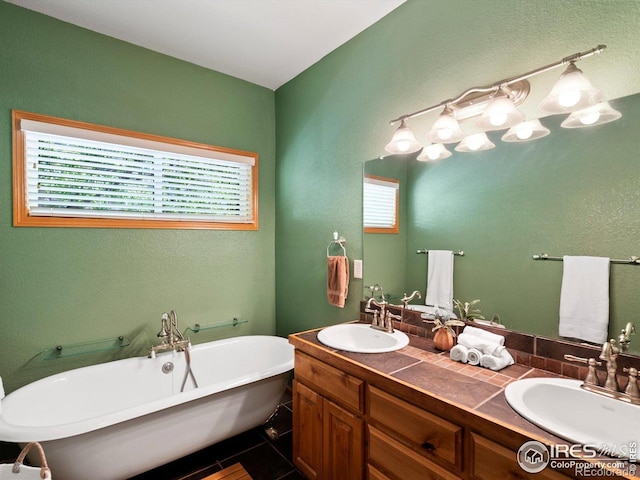 101 SE 2nd St, Berthoud, CO 80513 - full bathroom with healthy amount of natural light, double vanity, a freestanding bath, and a textured wall