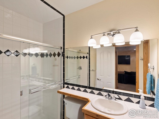 101 SE 2nd St, Berthoud, CO 80513 - bathroom with vanity, toilet, and a shower stall