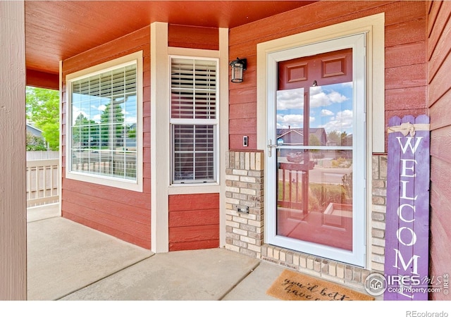 3255 Thundering Herd Way, Wellington, CO 80549 - view of exterior entry with covered porch and stone siding