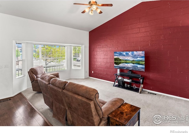 3255 Thundering Herd Way, Wellington, CO 80549 - living room featuring ceiling fan, lofted ceiling, brick wall, baseboards, and wood finished floors