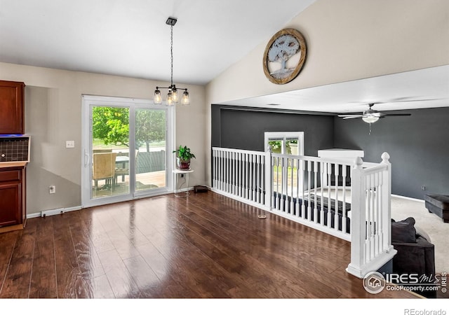 3255 Thundering Herd Way, Wellington, CO 80549 - empty room with vaulted ceiling, wood finished floors, ceiling fan, a chandelier, and healthy amount of natural light