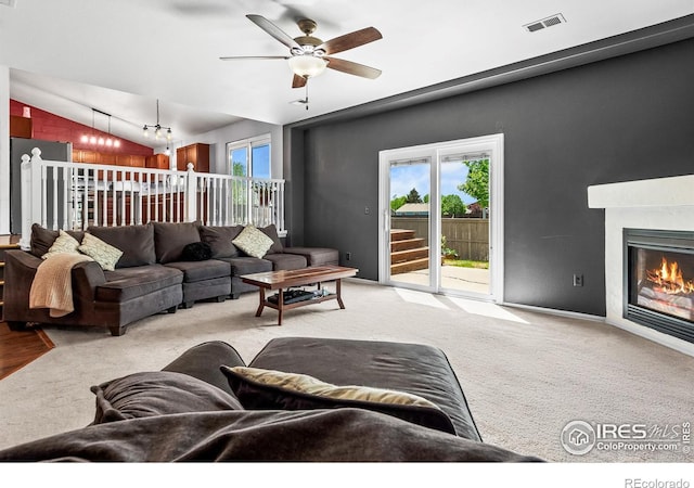 3255 Thundering Herd Way, Wellington, CO 80549 - living area featuring lofted ceiling, ceiling fan, carpet, and a fireplace
