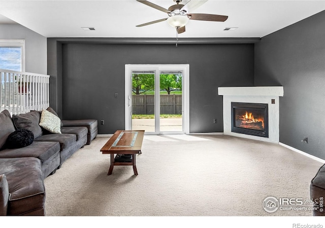 3255 Thundering Herd Way, Wellington, CO 80549 - carpeted living room featuring a ceiling fan, a glass covered fireplace, and baseboards