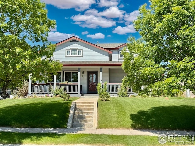 395 Longspur Dr, Brighton, CO 80601 - view of front facade featuring covered porch and a front lawn