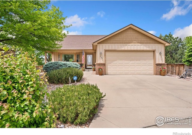 201 Timber Ridge Ct, Severance, CO 80550 - view of front facade featuring an attached garage, driveway, brick siding, and board and batten siding