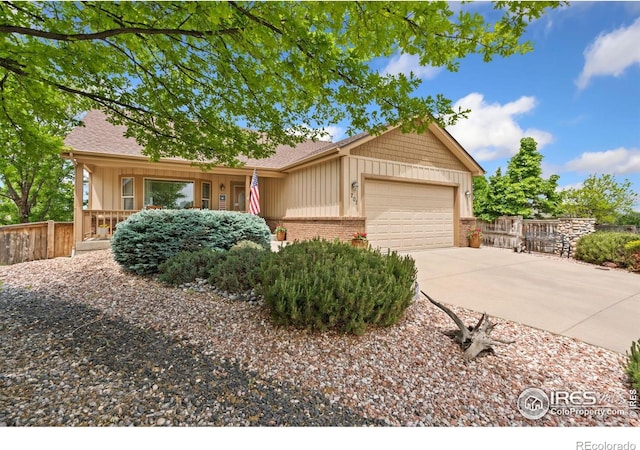201 Timber Ridge Ct, Severance, CO 80550 - ranch-style home with an attached garage, concrete driveway, board and batten siding, and brick siding