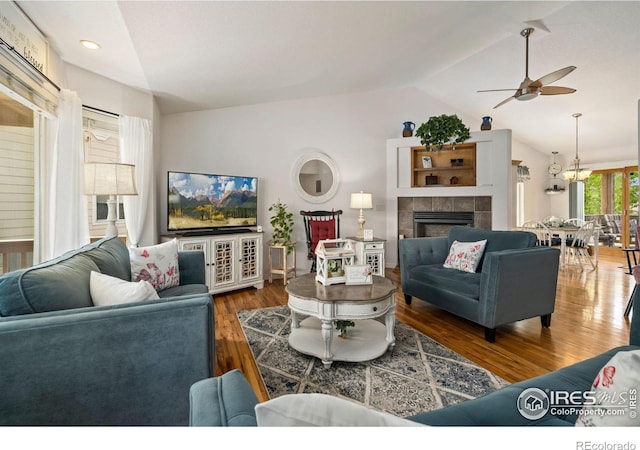 201 Timber Ridge Ct, Severance, CO 80550 - living area with lofted ceiling, a ceiling fan, wood finished floors, a tiled fireplace, and recessed lighting