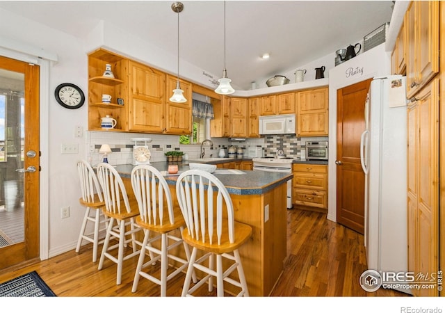 201 Timber Ridge Ct, Severance, CO 80550 - kitchen with white appliances, a peninsula, decorative backsplash, dark wood-style floors, and recessed lighting