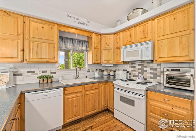 201 Timber Ridge Ct, Severance, CO 80550 - kitchen with white appliances, a sink, dark countertops, and tasteful backsplash