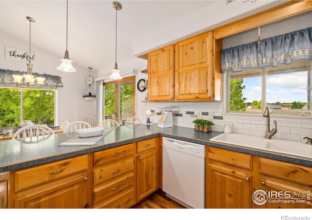 201 Timber Ridge Ct, Severance, CO 80550 - kitchen with dishwasher, a sink, tasteful backsplash, hanging light fixtures, and dark countertops