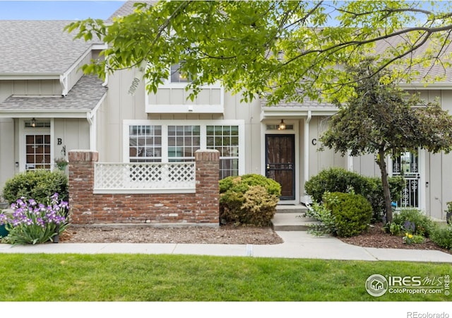 2982 W Long Dr # C, Littleton, CO 80120 - view of front of house featuring board and batten siding and a shingled roof