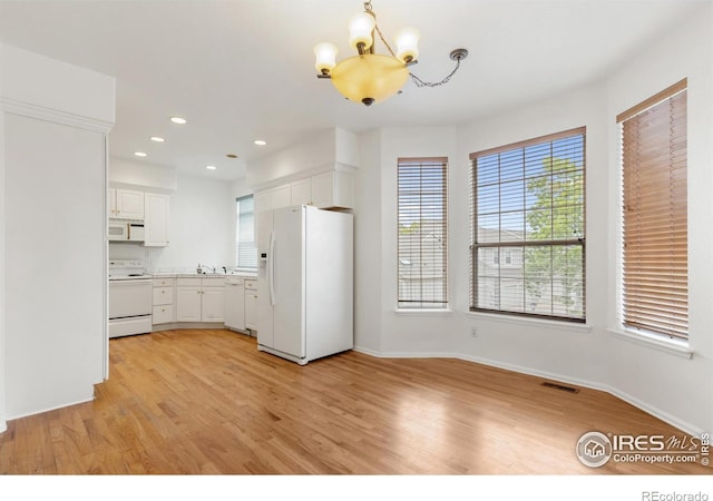 2982 W Long Dr # C, Littleton, CO 80120 - kitchen featuring white appliances, a chandelier, light wood-style floors, white cabinets, and recessed lighting