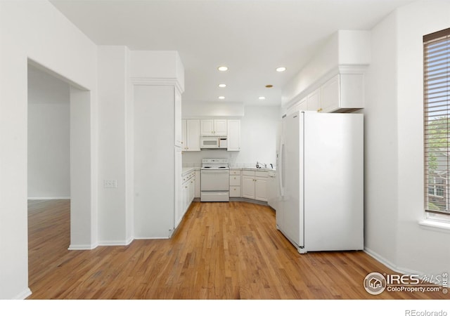 2982 W Long Dr # C, Littleton, CO 80120 - kitchen with white appliances, white cabinetry, light wood-style floors, recessed lighting, and light countertops