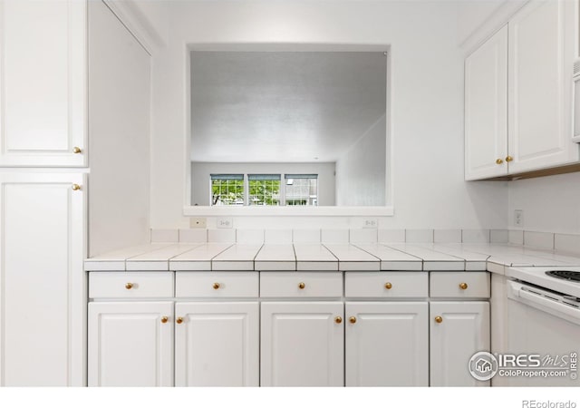 2982 W Long Dr # C, Littleton, CO 80120 - kitchen featuring white cabinets, tile counters, and white electric stove