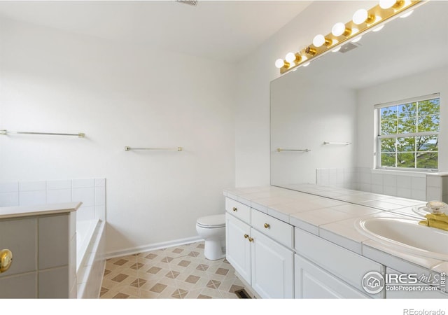 2982 W Long Dr # C, Littleton, CO 80120 - full bathroom featuring vanity, a garden tub, toilet, and baseboards