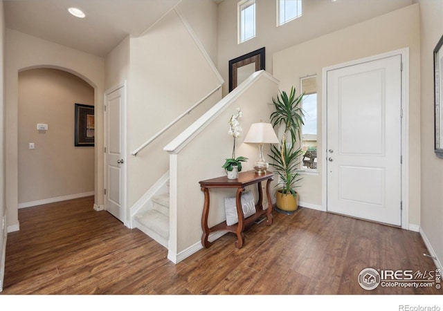 7401 Pimlico Dr, Windsor, CO 80550 - entryway featuring arched walkways, stairway, wood finished floors, baseboards, and recessed lighting