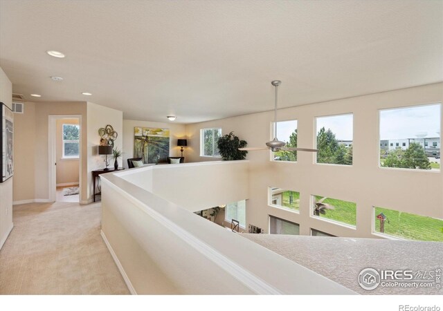 7401 Pimlico Dr, Windsor, CO 80550 - hallway with recessed lighting, baseboards, light colored carpet, and an upstairs landing