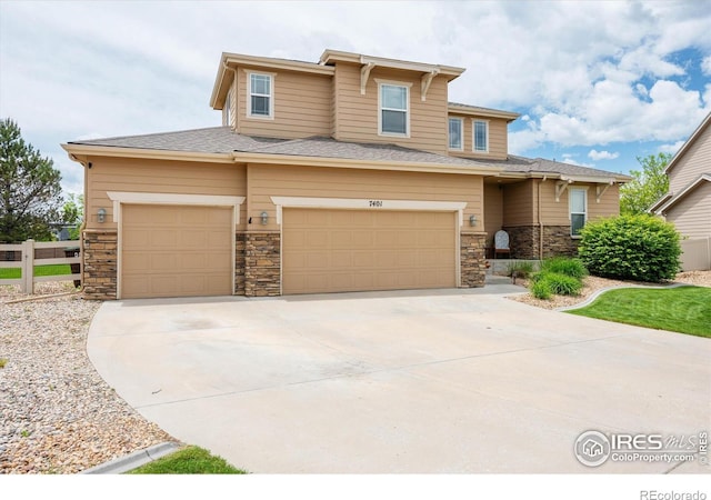 7401 Pimlico Dr, Windsor, CO 80550 - prairie-style home featuring an attached garage, stone siding, concrete driveway, and roof with shingles