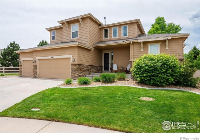 7401 Pimlico Dr, Windsor, CO 80550 - view of front of home featuring driveway, a garage, and stone siding